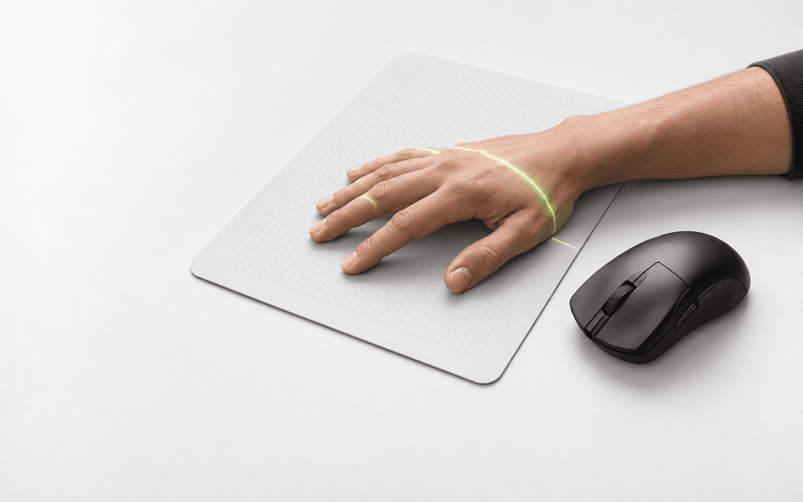 Hand on a mousepad with a green measurement scan and a mouse beside it