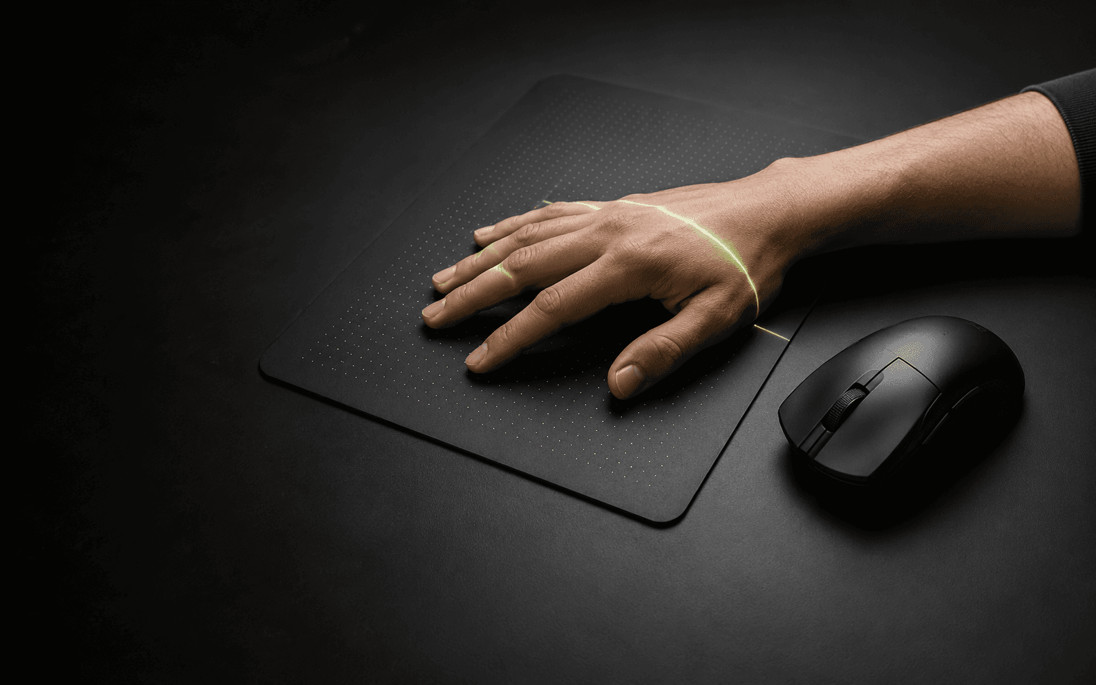 Hand on a mousepad with a green measurement scan and a mouse beside it