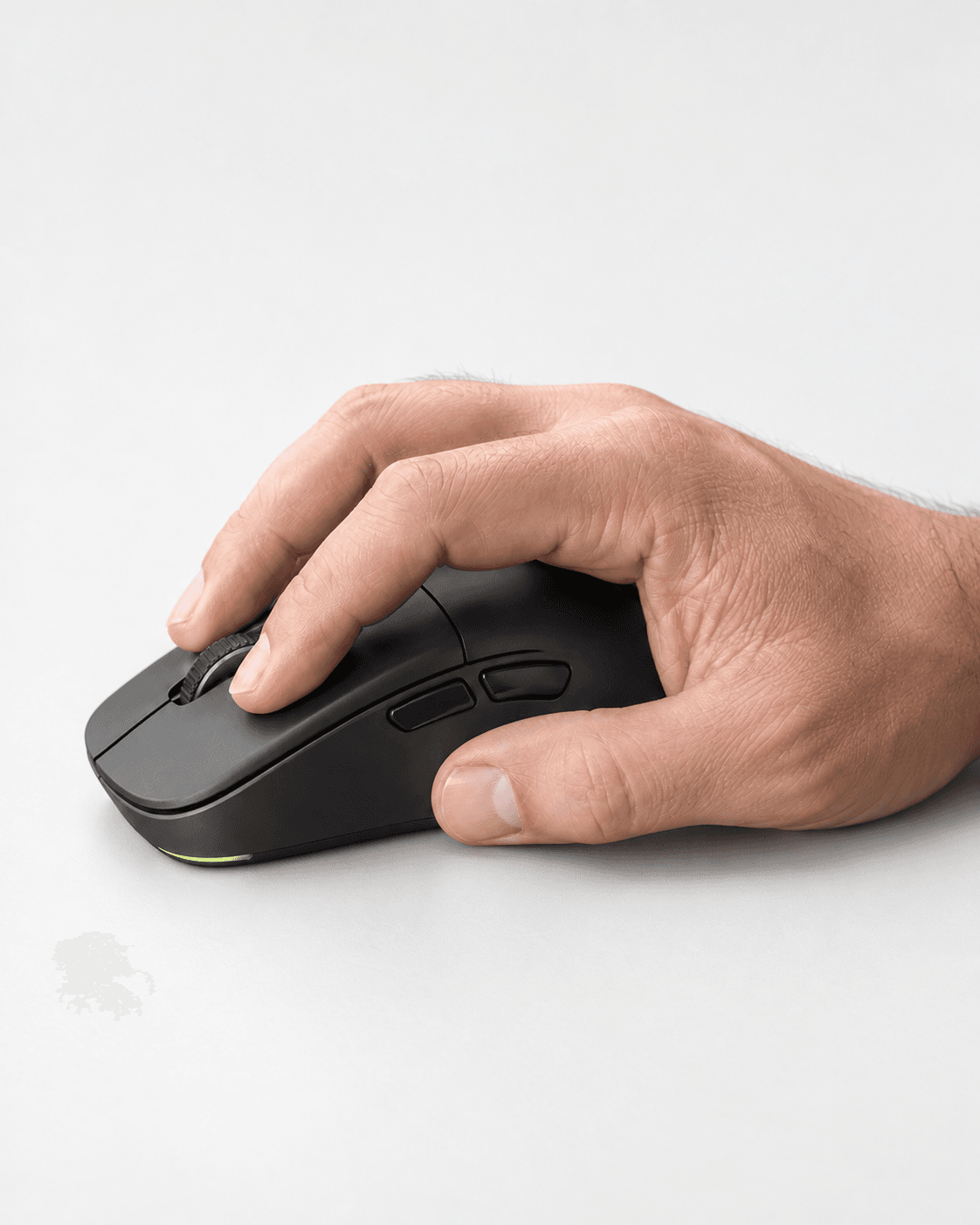 Hand holding a mouse in a natural grip position