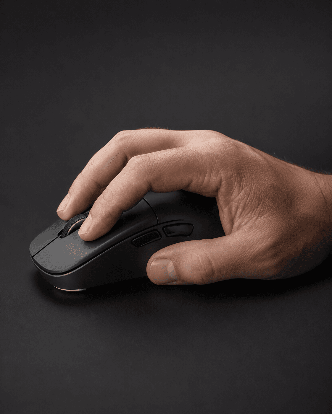 Hand holding a mouse in a natural grip position